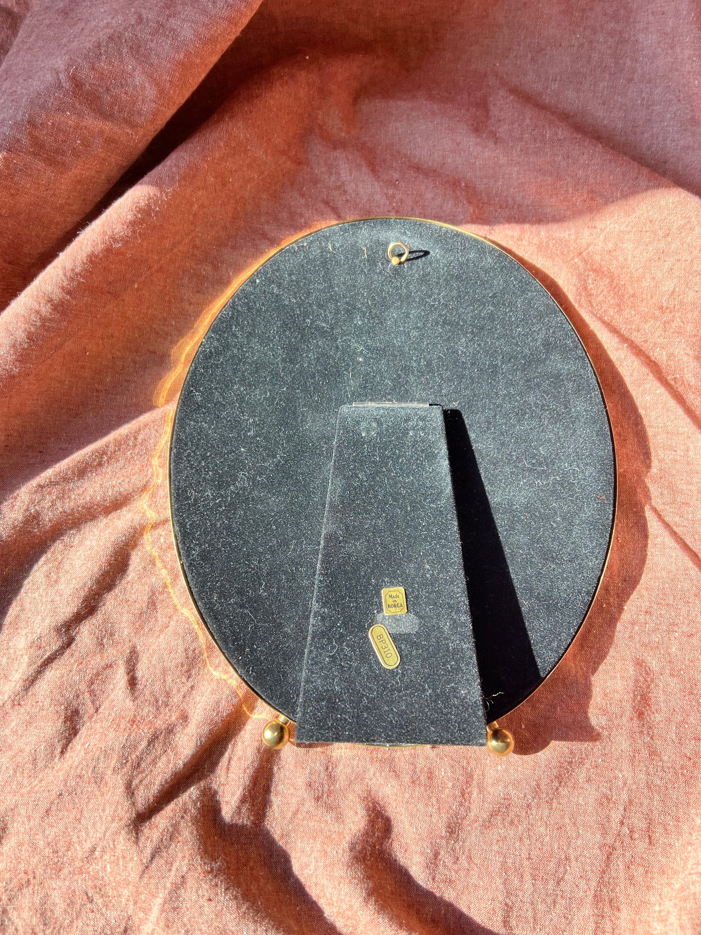 Large brass oval frame